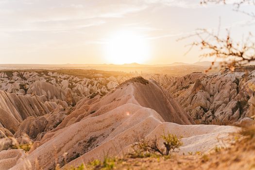 Stunning view of Cappadocia's unique rock formations under the golden sunset light.