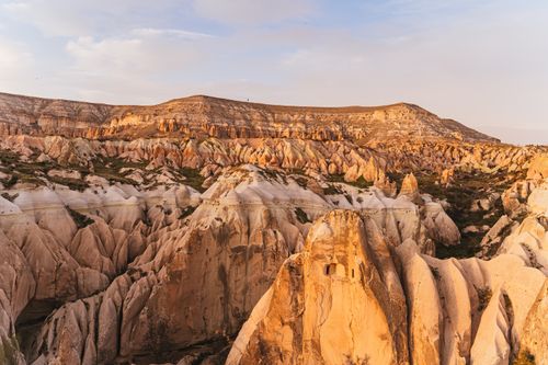 Free Explore the breathtaking rock formations of Cappadocia as the sun sets, showcasing the region's natural beauty. Stock Photo