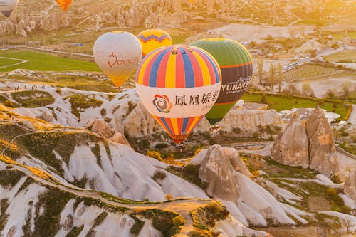 Free Hot Air Balloons Flying Over the Mountain Stock Photo