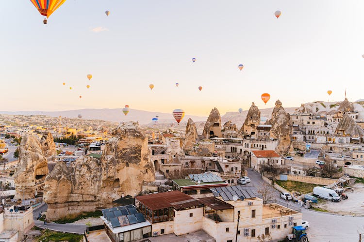 Hot Air Balloons Flying Over City Buildings