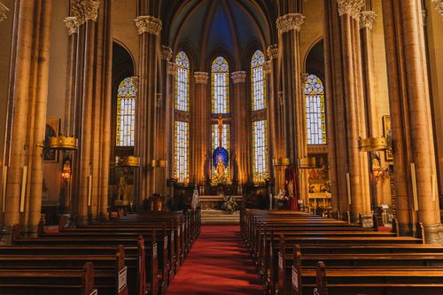 Free Stunning view of a cathedral interior highlighting stained glass windows and religious architecture. Stock Photo