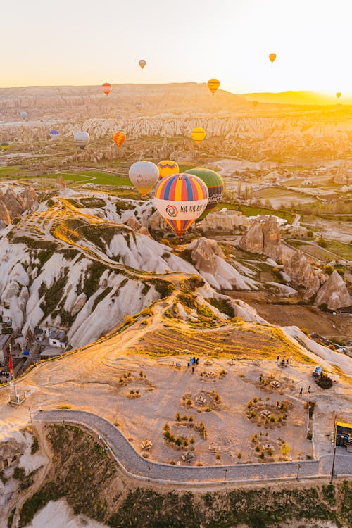 Free Hot Air Balloons Flying Over the Brown Field Stock Photo