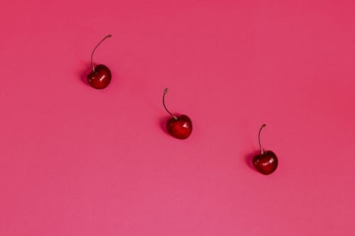 Cherry Fruits on Pink Surface