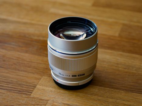 Black and Silver Camera Lens on Brown Wooden Table