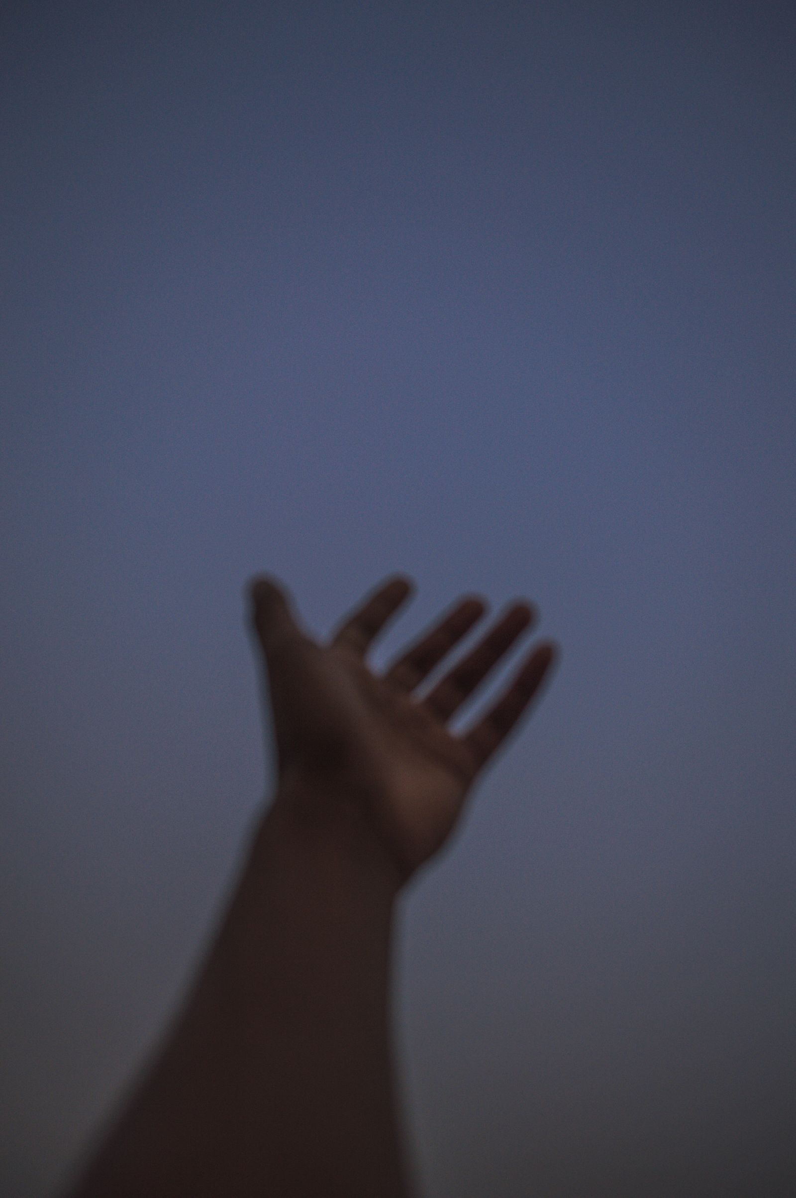 Hand reaching toward the sun