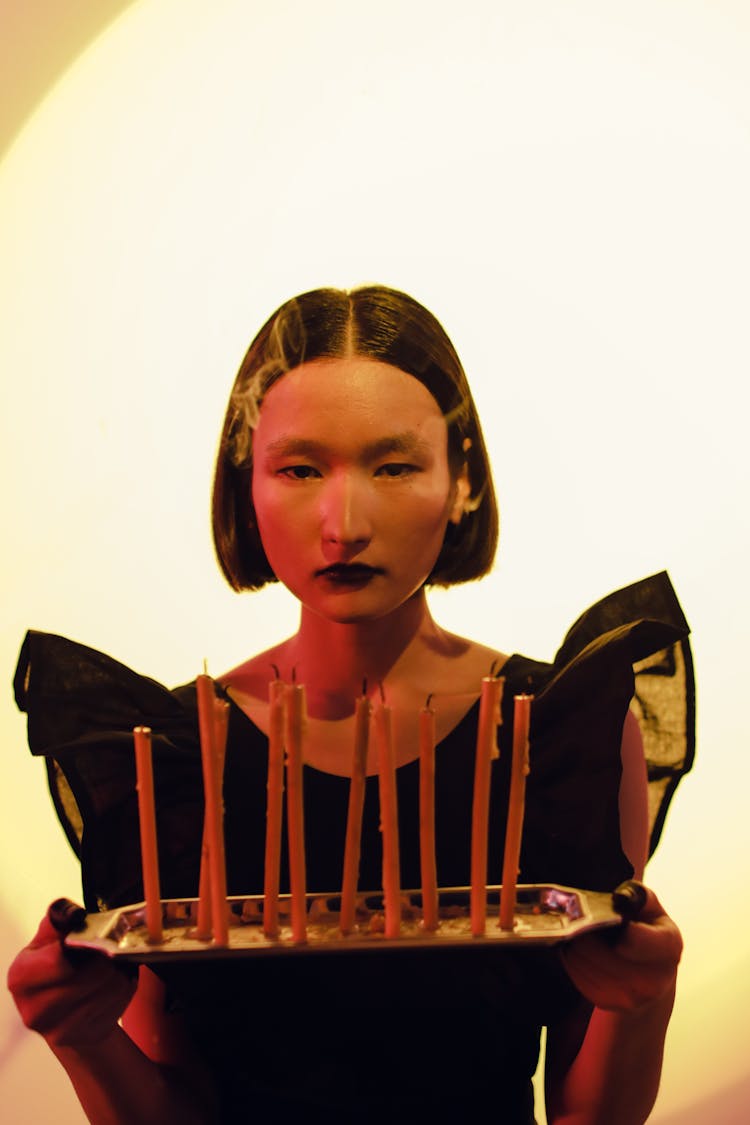 Woman Holding A Tray Of Candles