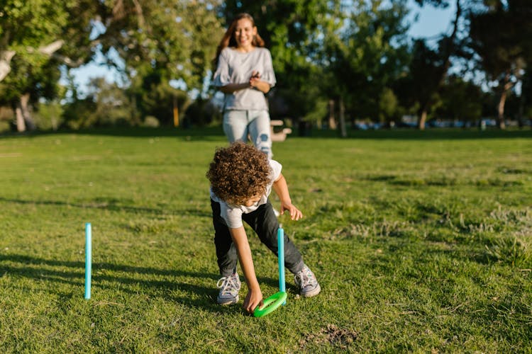 Mother And Son Playing At The Park