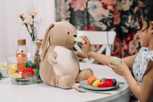 Free Cute Girl Playing with Her Stuffed Animal Stock Photo