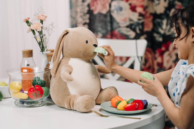 Cute Girl Playing With Her Stuffed Animal