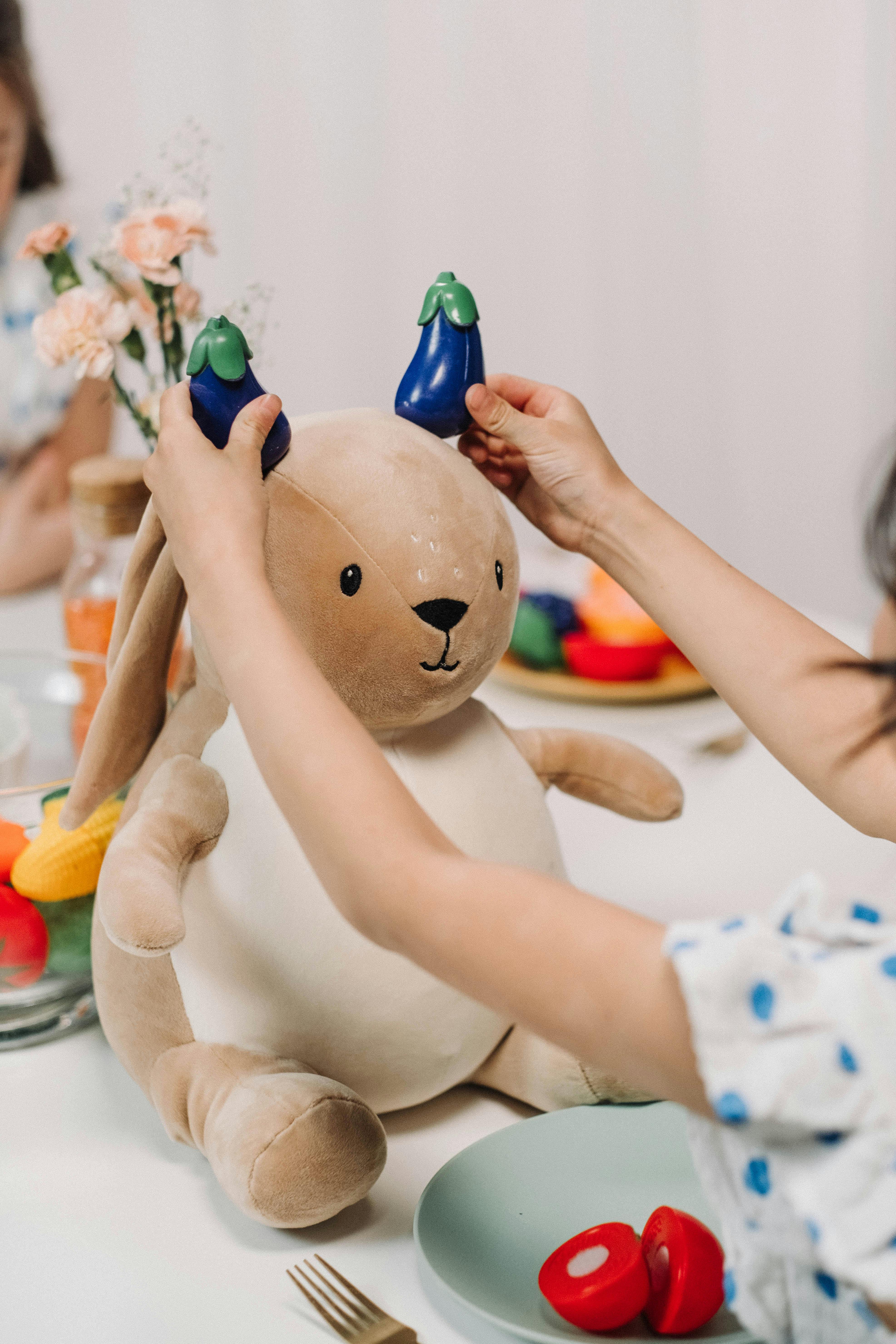 a kid playing with stuffed animal