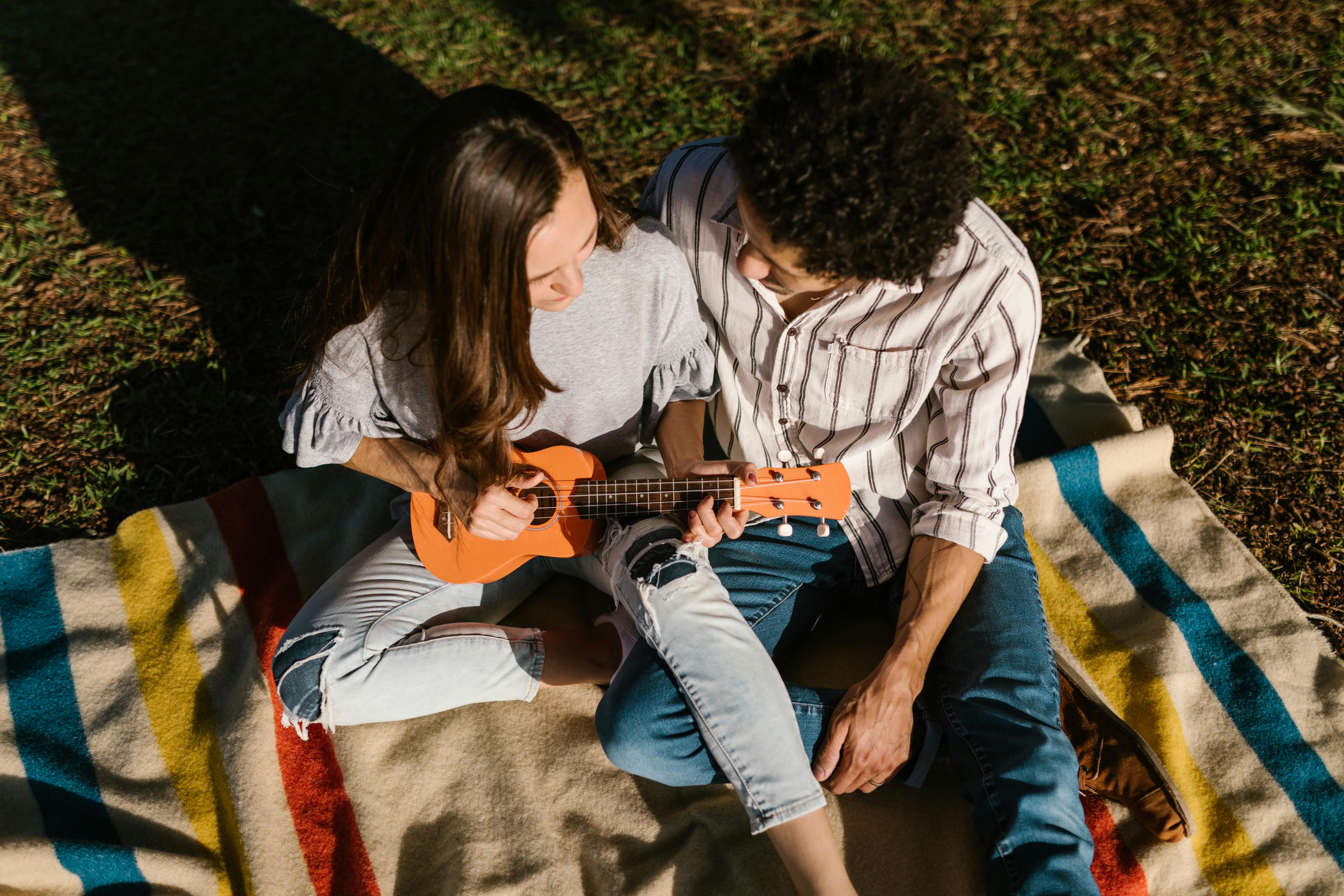 high angle shot of a romantic couple sitting on picnic blanket