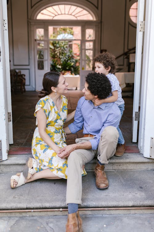 Free A Family Sitting at the Doorway Stock Photo