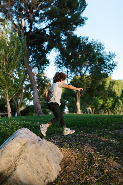Free A Young Boy Running Outside Stock Photo