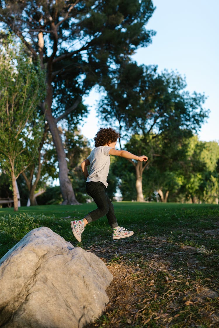 A Young Boy Running Outside