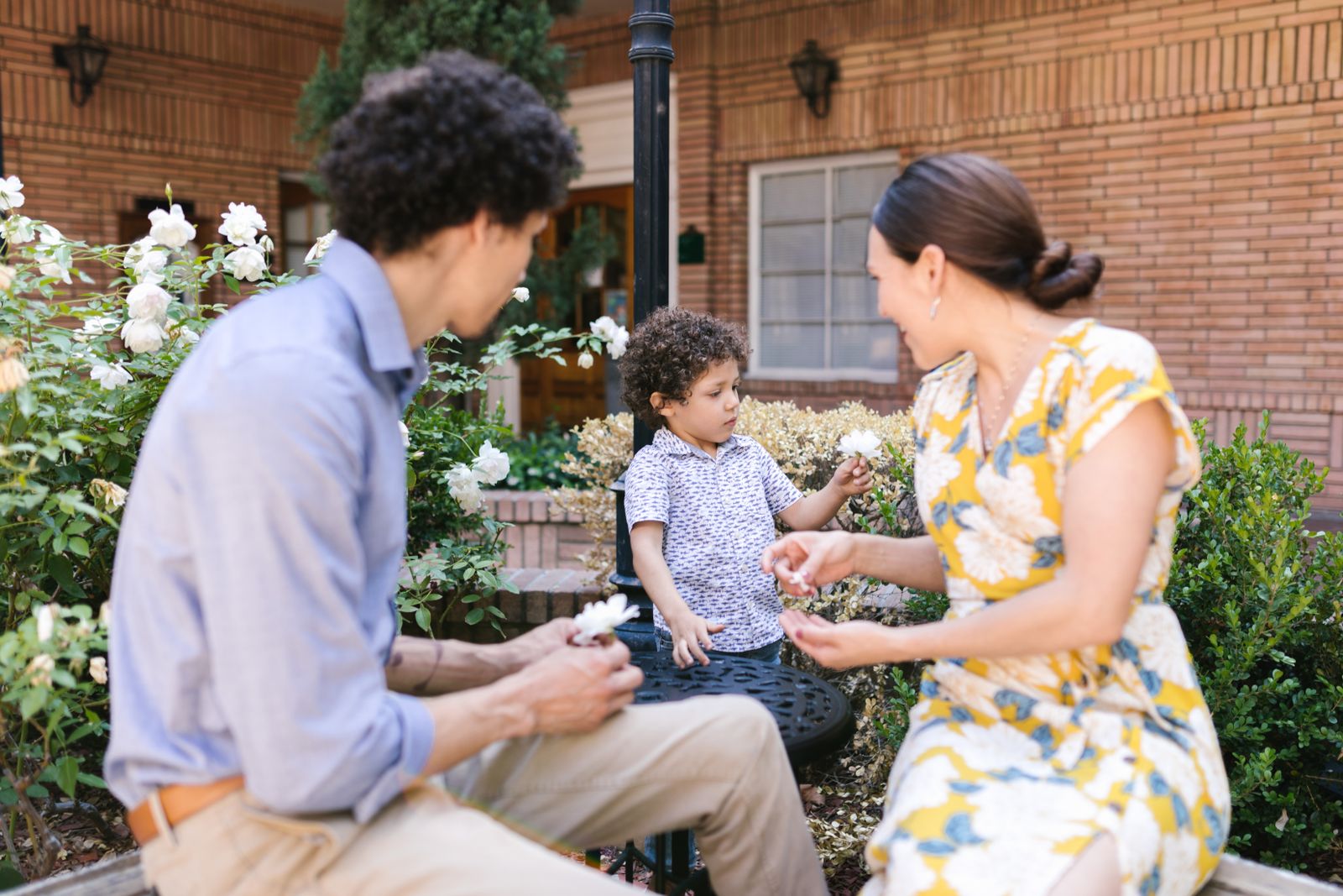 A family enjoying time together in a lush blooming garden