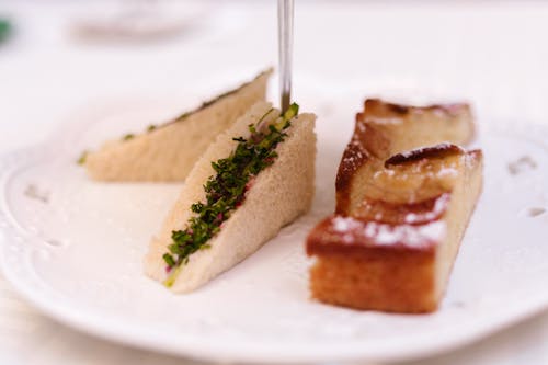 Free Close-up of Sandwiches and a Slice of Cake on a Plate  Stock Photo