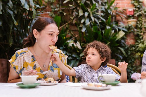 Photo of a Boy Feeding His Mother