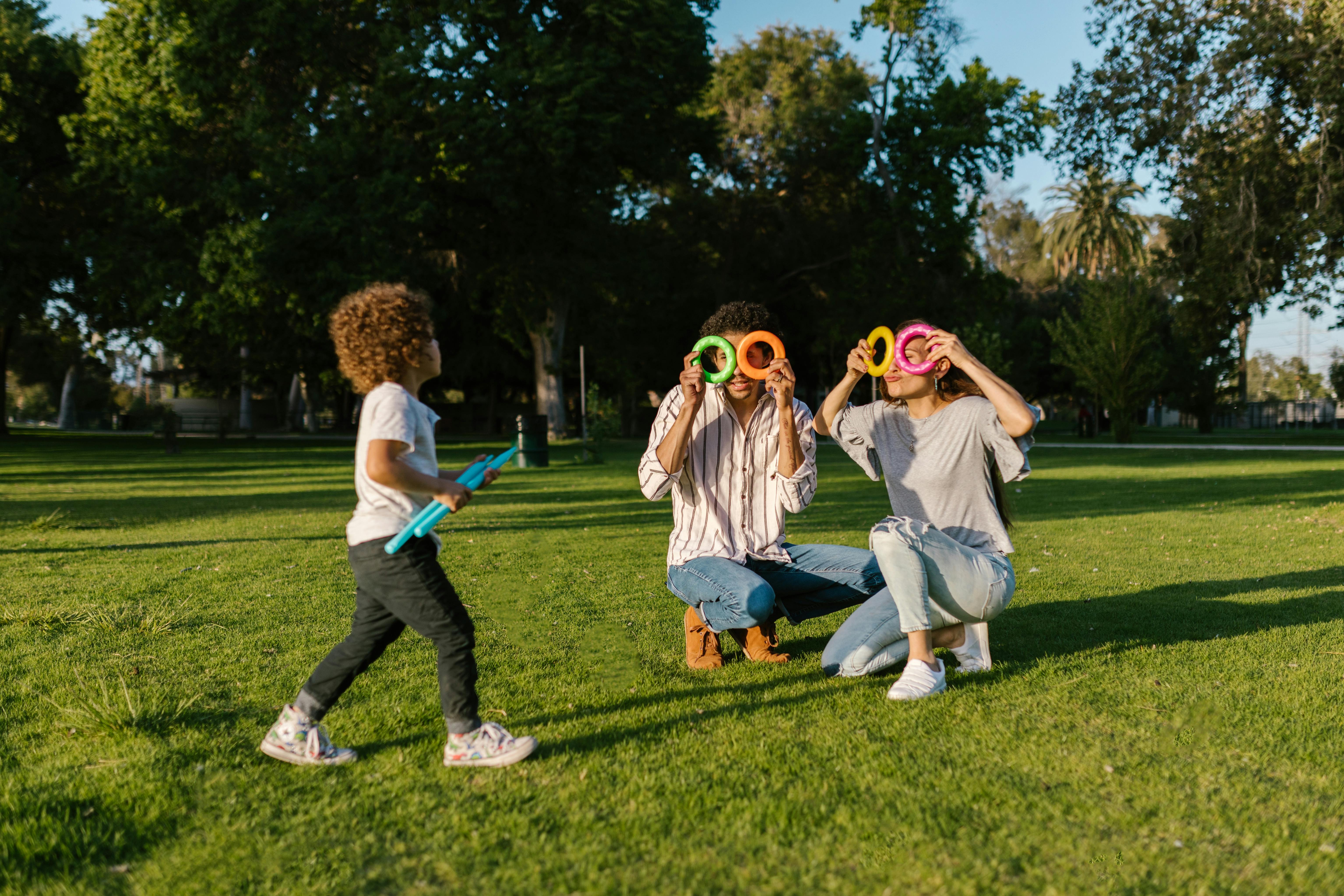 Free Family Playing in the Park with Toys Stock Photo
