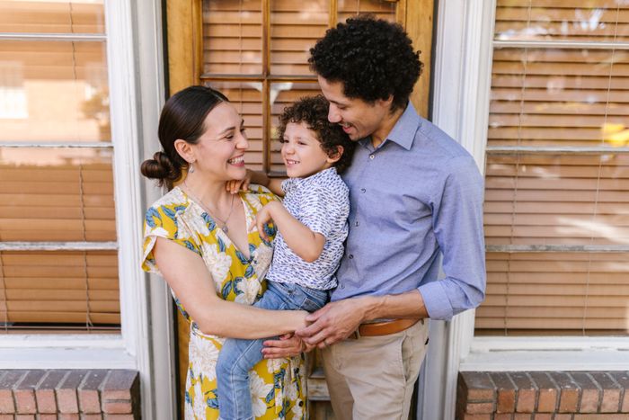 Happy homeowner family by their sparkling clean windows
