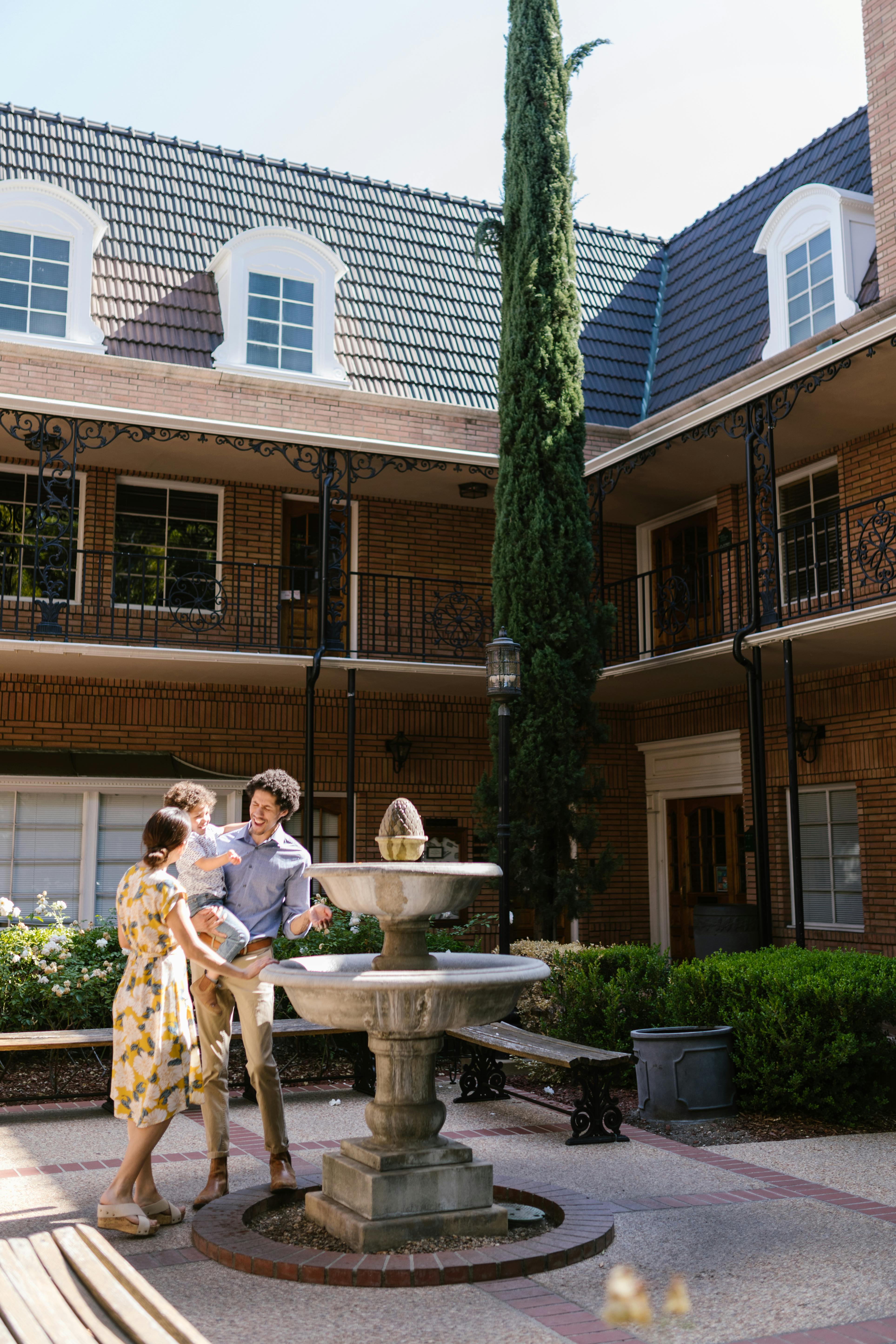 photograph of a family standing near a fountain