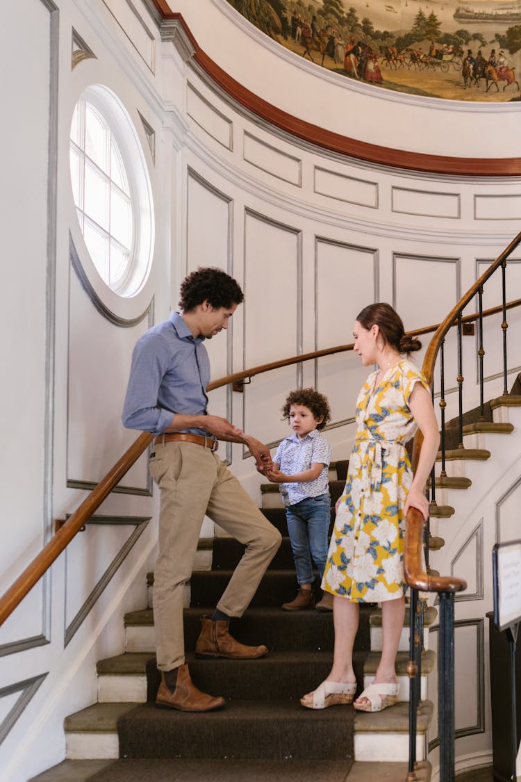 Photo Of A Family Standing On A Staircase