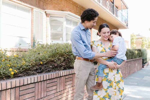 Free Photograph of a Mother Carrying Her Son Stock Photo