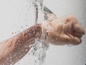 Person's Left Fist Punching Water