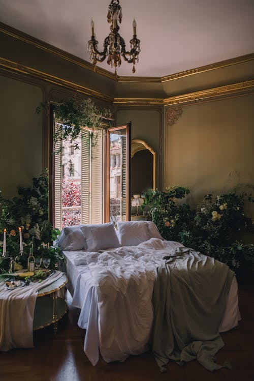 Free Interior of a Bedroom with Lots of Plants and Decorated in a Vintage, Luxurious Style  Stock Photo