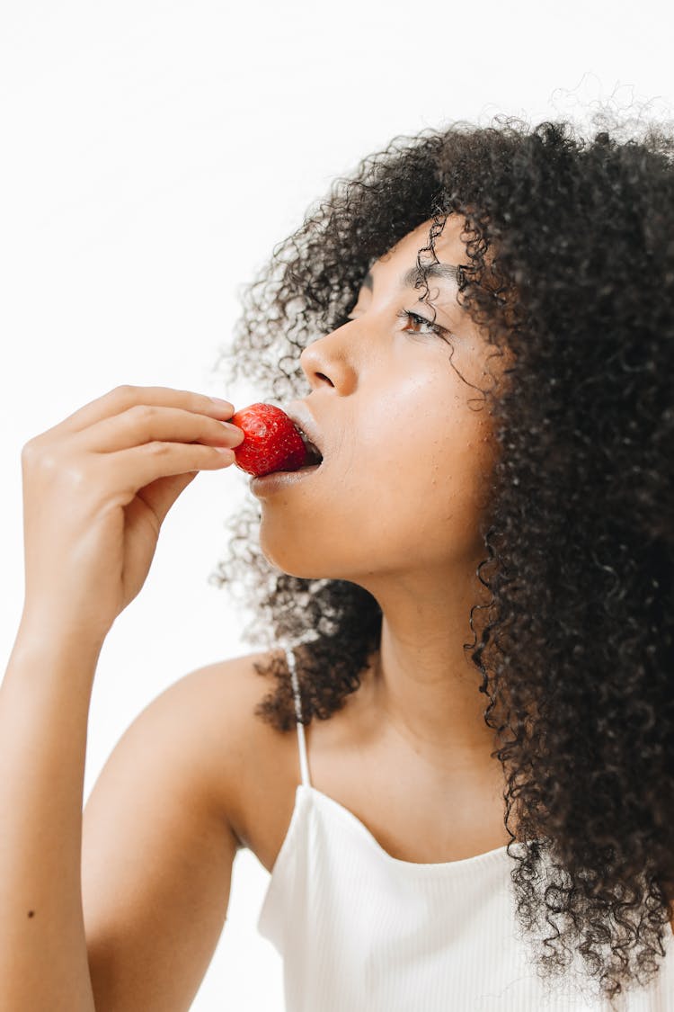 A Woman Eating A Strawberry