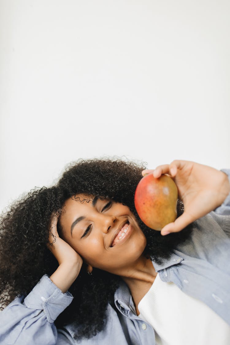 Woman Holding A Fresh Mango