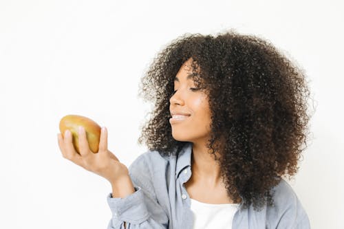 A Woman Looking at a Mango