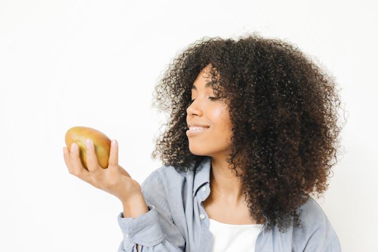 A Woman Looking At A Mango