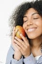 Woman Holding Orange Fruit Smiling