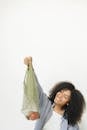 Woman in Black Jacket Holding Green Net
