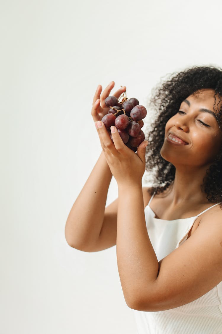 Smiling Woman With Plums