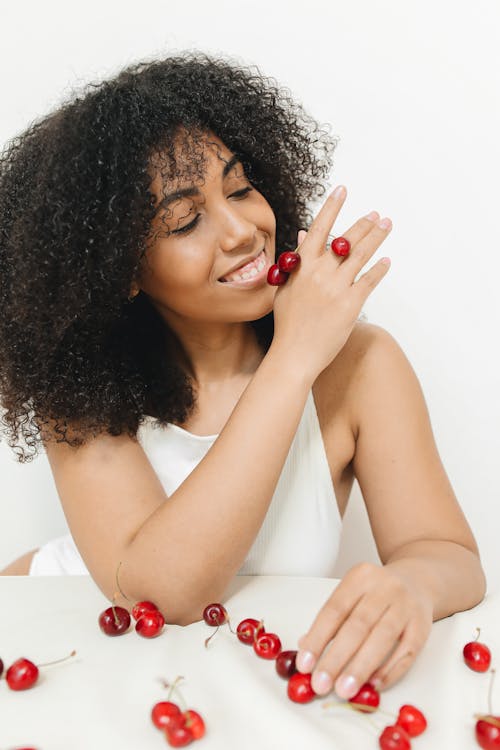 Photo of a Woman Holding Cherries