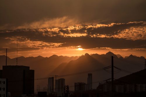 Free Beautiful sunset over Monterrey skyline with mountains and silhouetted buildings. Stock Photo