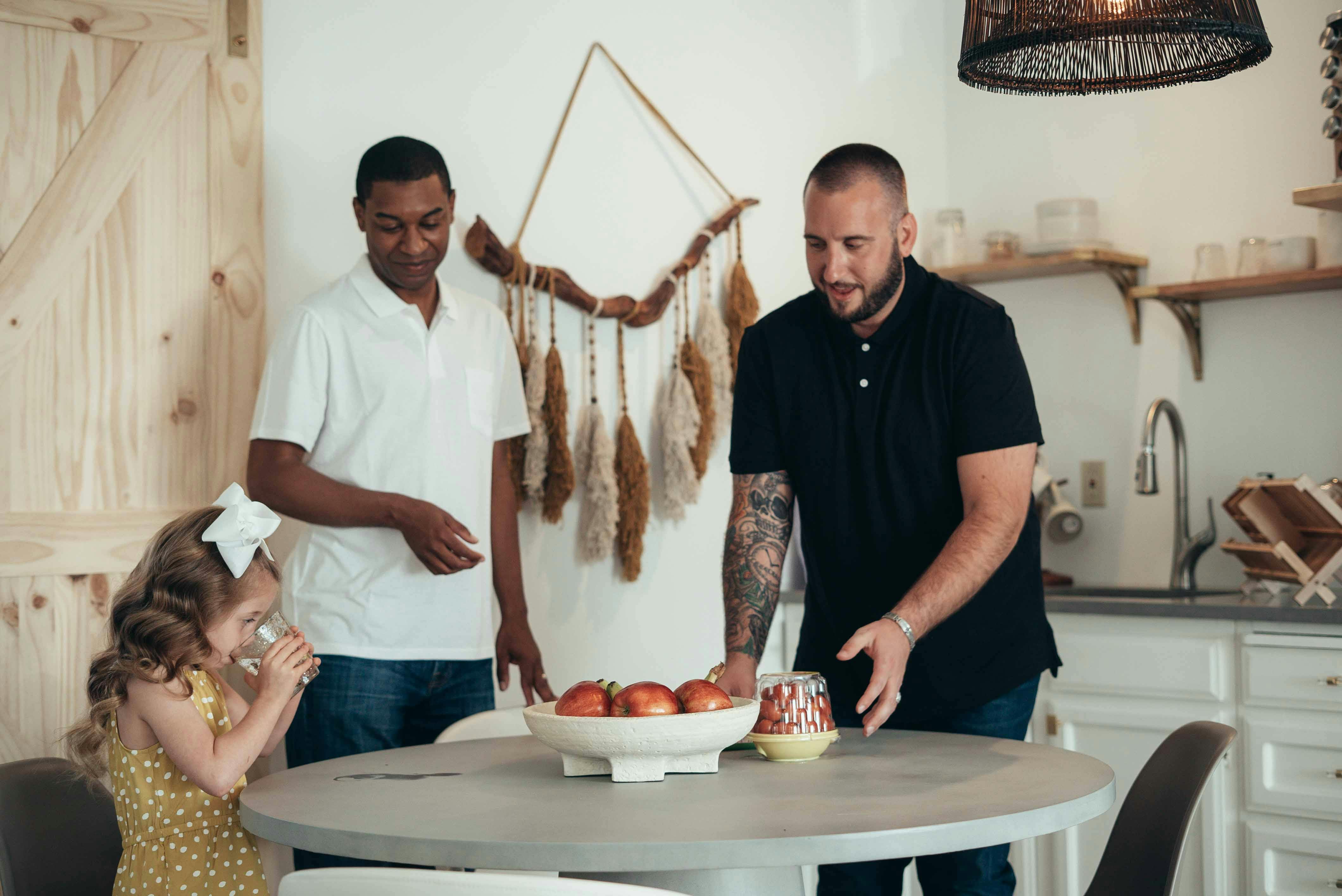 fathers and their daughter in a kitchen during breakfast