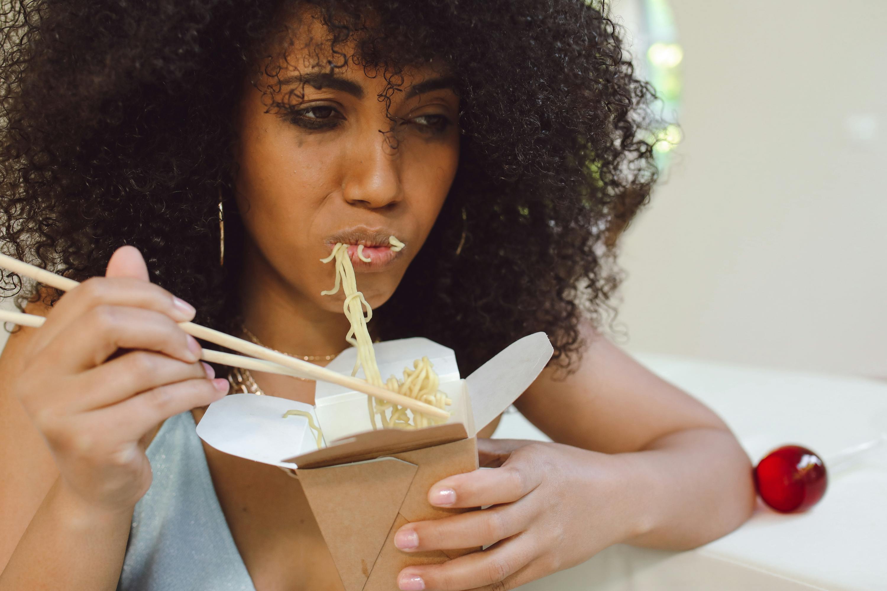 Woman Eating Take Out Noodle · Free Stock Photo