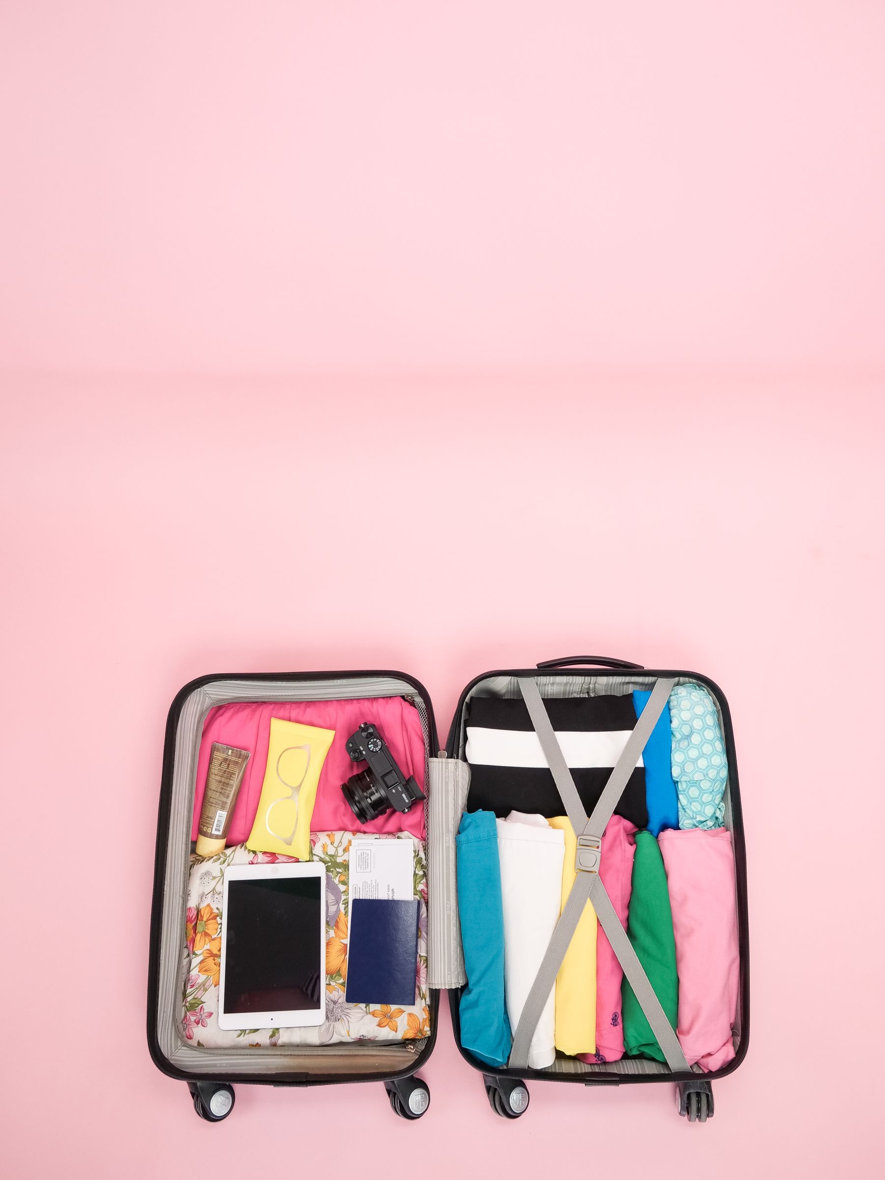 Open suitcase with travel accessories organized for a trip
