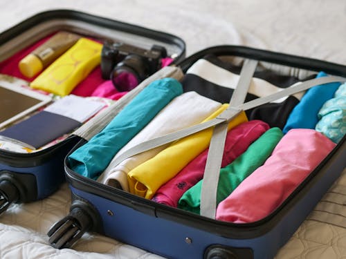 Free Blue Luggage with Folded Clothes  Stock Photo