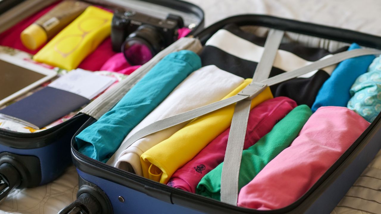 Finished lightweight travel suitcase Neatly organized lightweight suitcase prepared for a trip