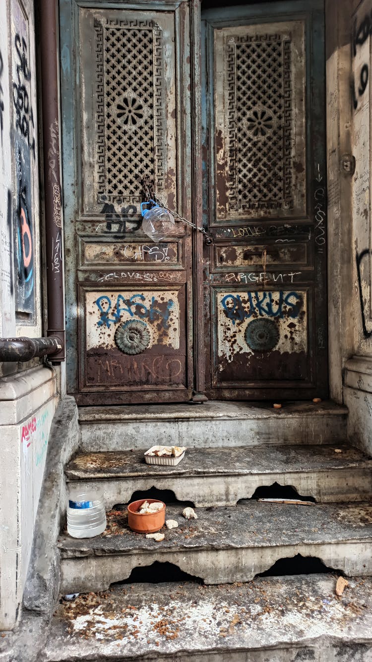 Old Ornate Door With Objects Left On Steps