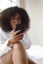 Woman with Curly Hair Shocked at Something She Saw on Her Cellphone
