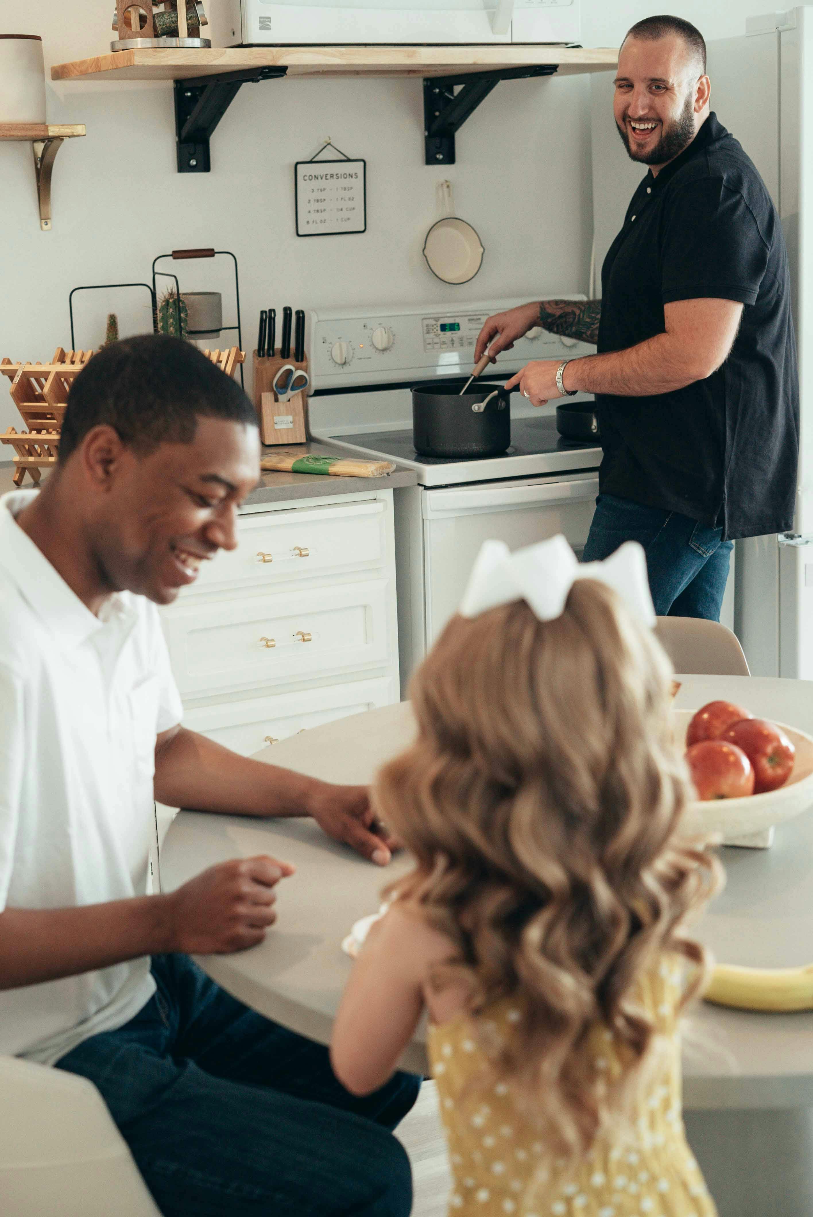 a smiling man cooking food for his family