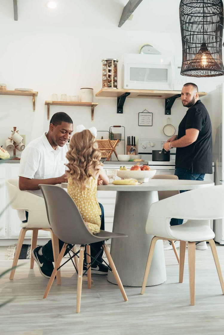 Happy Family Eating Meal In Kitchen