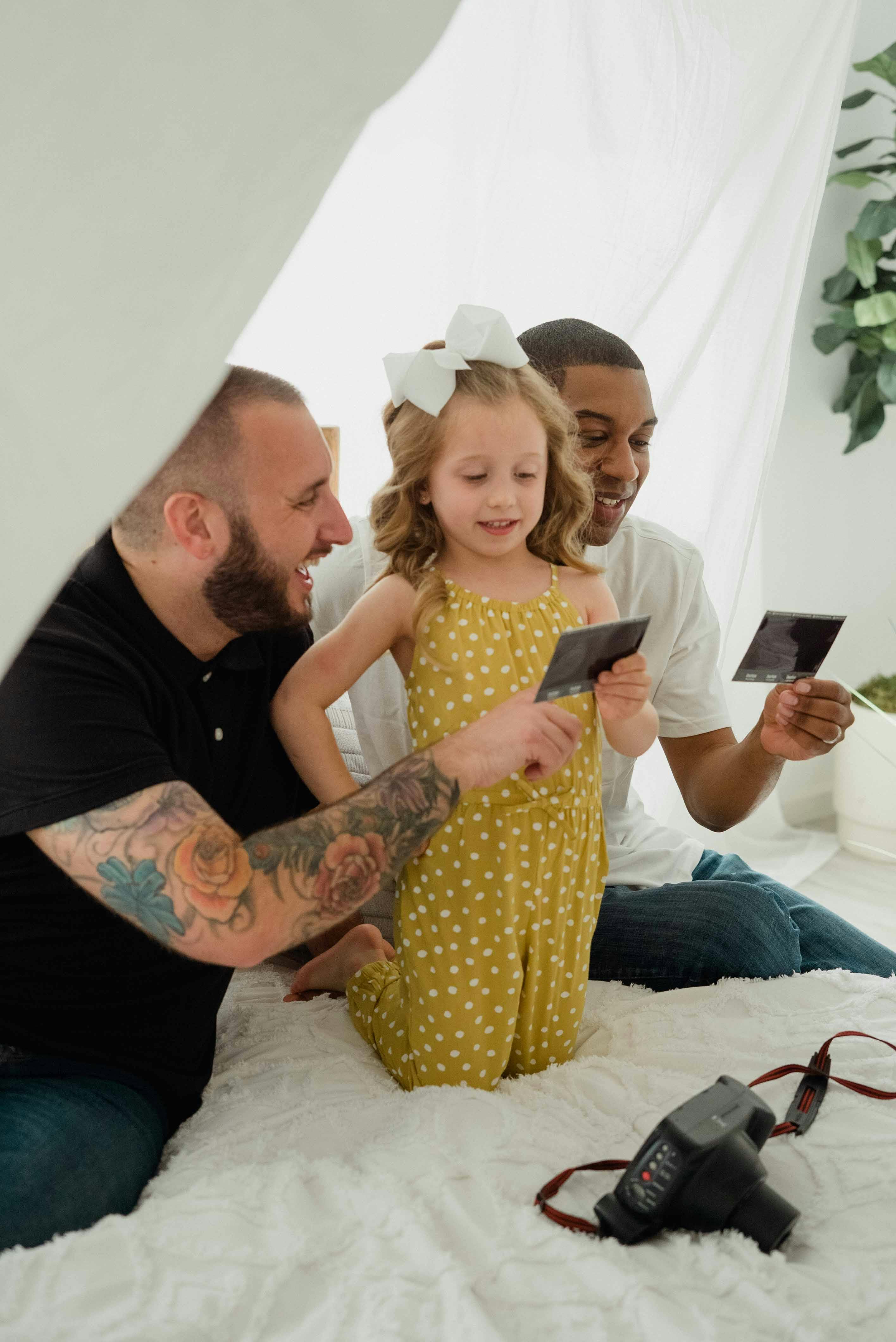 a family sitting on the bed