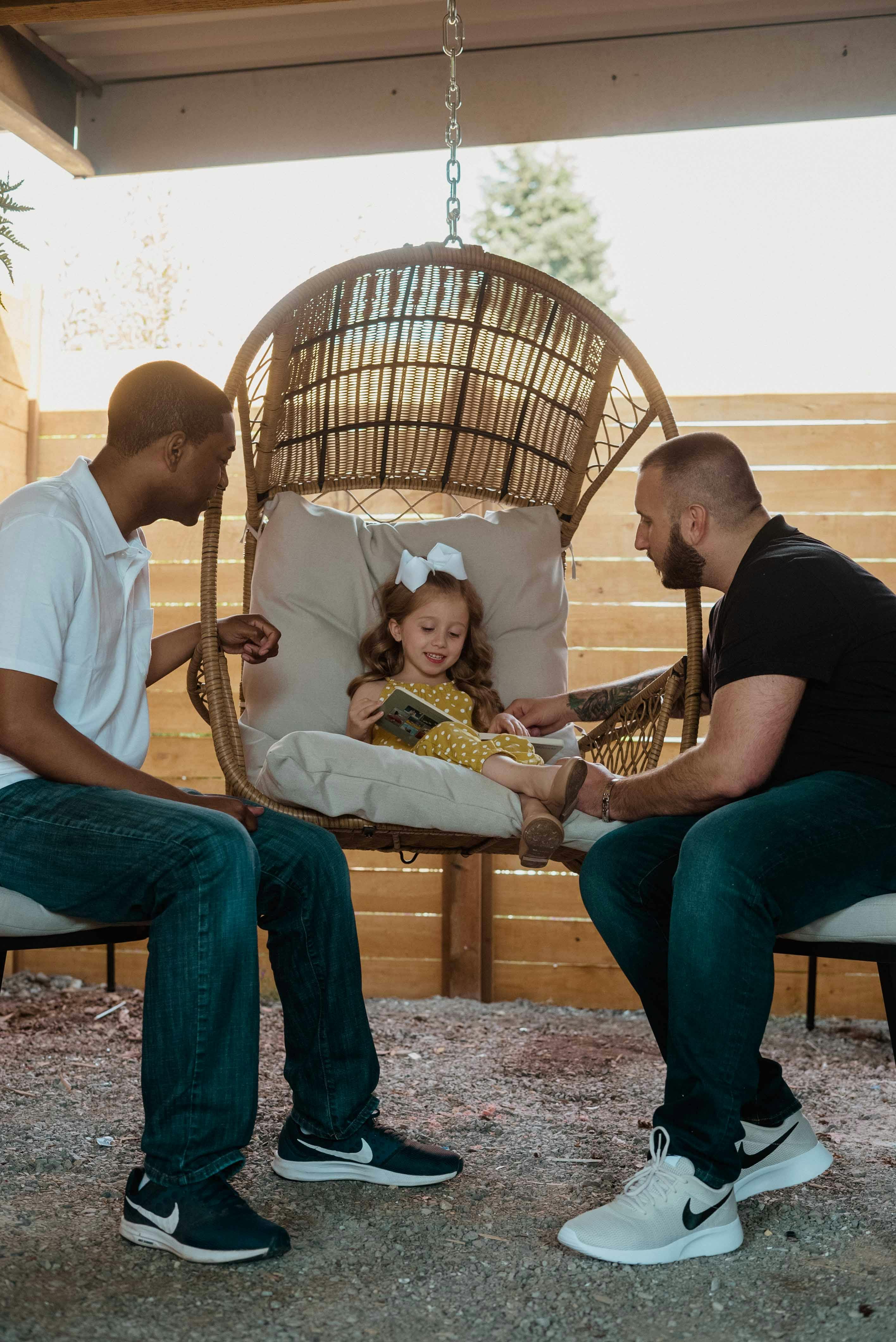 a couple with their daughter in the hammock