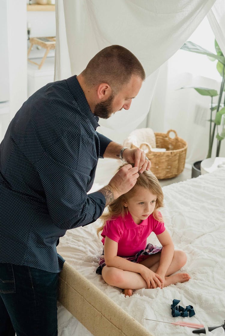 Photo Of A Father Fixing The Hair Of Her Daughter