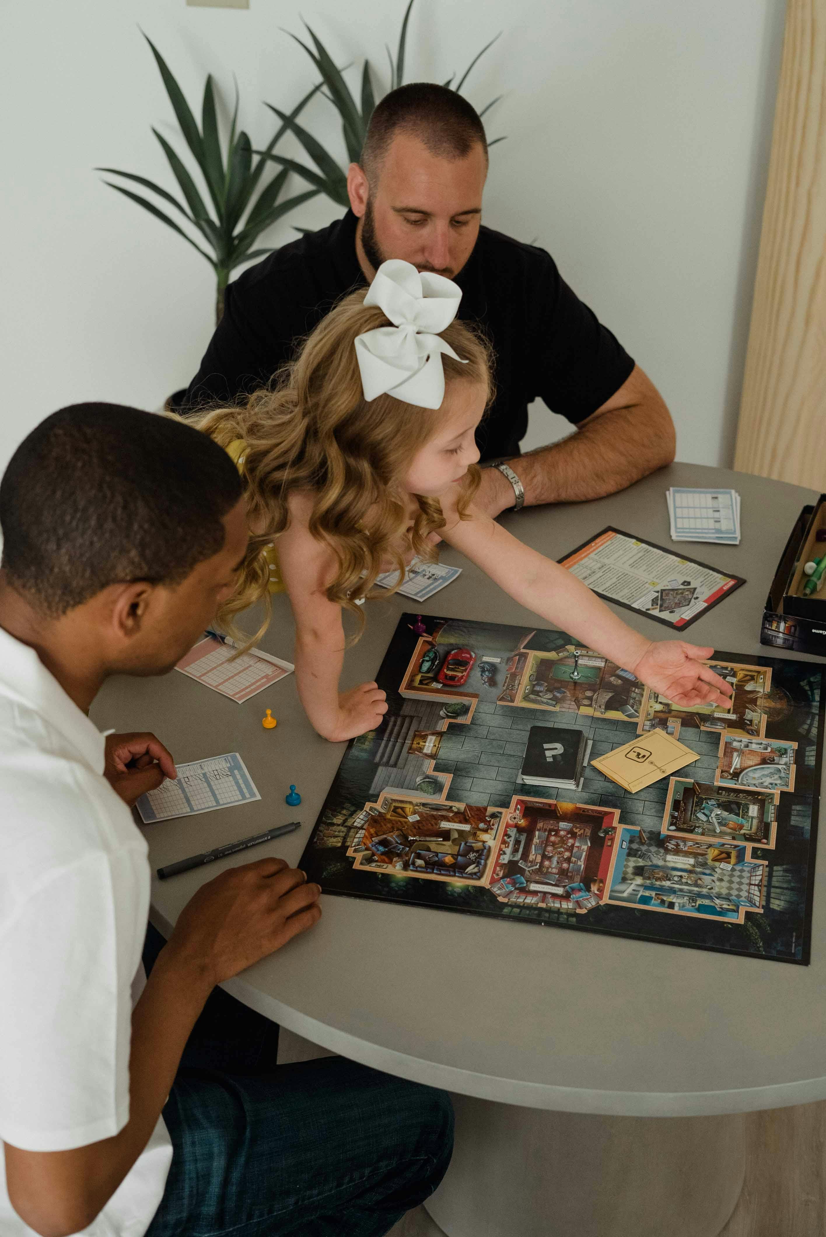 a couple playing with their daughter